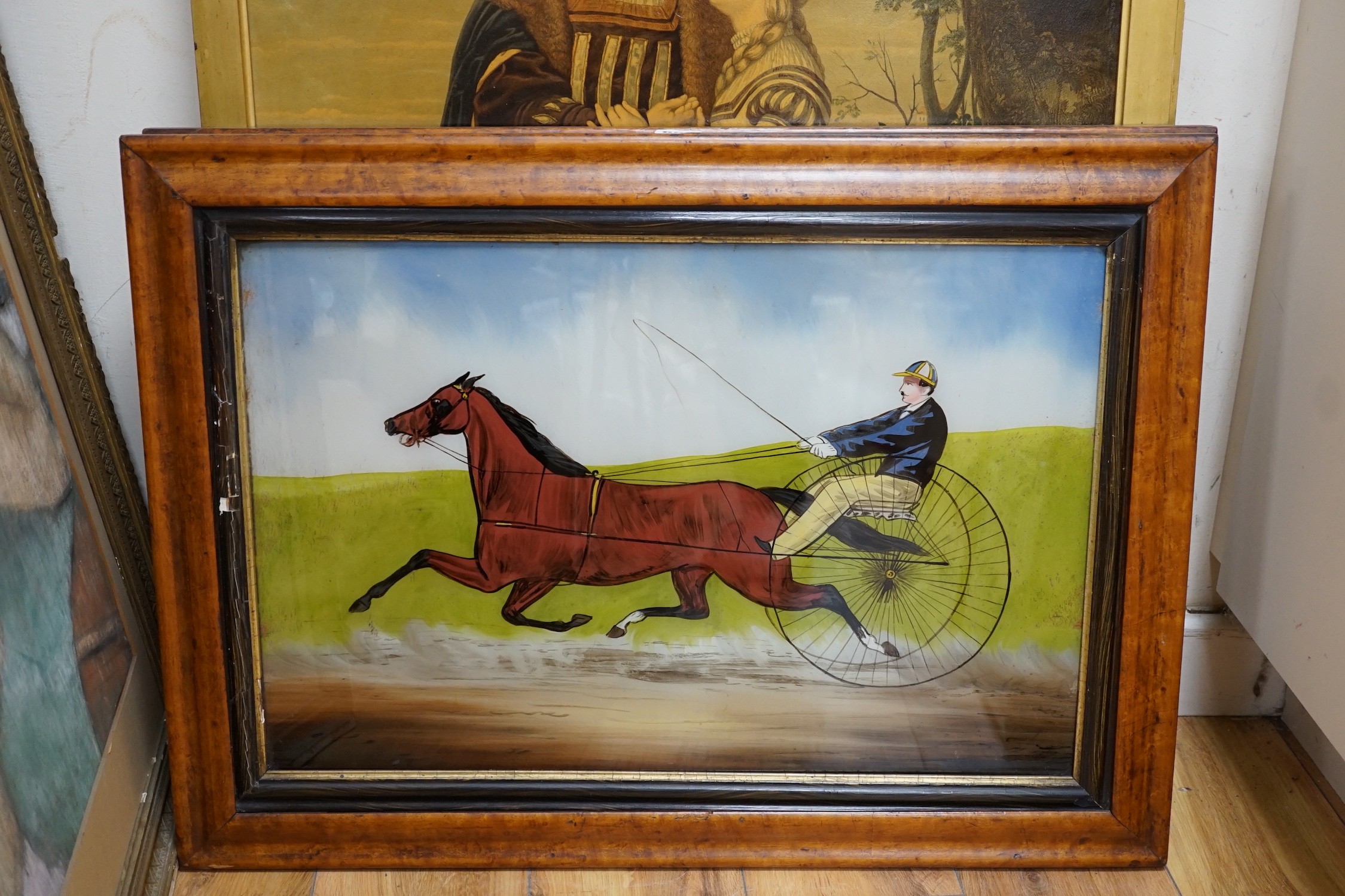 A pair of late Victorian reverse painting glass panels depicting racing gigs, 39 x 60cm, maple framed